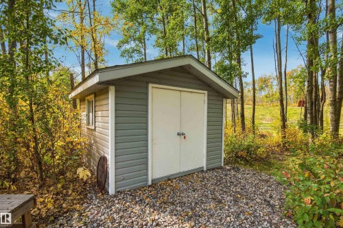 Detached storage shed with horizontal siding, a gabled roof, and double doors - 51064 Rge Rd 222, Rural Strathcona County, AB 