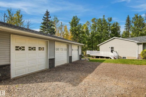 Three-car garage with panel doors and decorative window inserts - 51064 Rge Rd 222, Rural Strathcona County, AB 