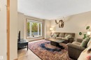 Large windows offering ample natural light, neutral wall colors, and wood-finish flooring - 51064 Rge Rd 222, Rural Strathcona County, AB 