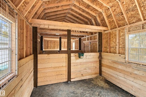 Exposed wood framing, durable concrete flooring, and windows with wire mesh screens - 51064 Rge Rd 222, Rural Strathcona County, AB 