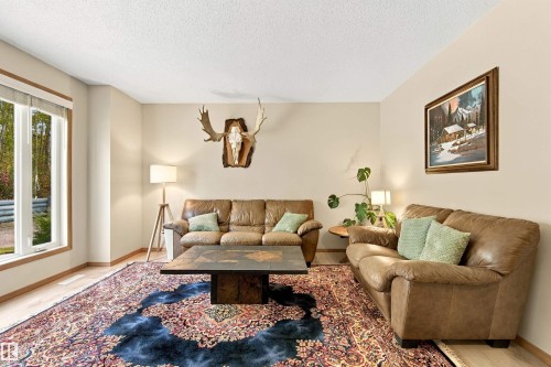 Recessed lighting, wood-finish flooring, and a large window with white trim - 51064 Rge Rd 222, Rural Strathcona County, AB 