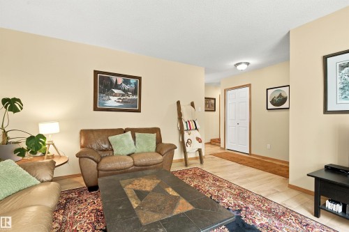 Light-toned walls, wood-finish flooring, white bi-fold door, and a flush mount ceiling light - 51064 Rge Rd 222, Rural Strathcona County, AB 