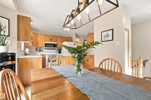 Kitchen featuring wood-finish cabinetry, white appliances, and a built-in microwave - 51064 Rge Rd 222, Rural Strathcona County, AB 