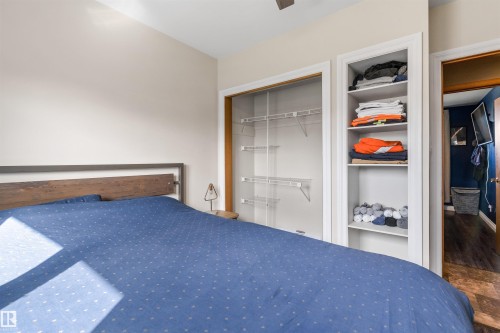 Bedroom featuring a built-in closet with wire shelving and recessed open-faced cabinetry with fixed shelving - 6207 85 Avenue Nw, Edmonton, AB 