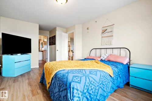 Wood-finish flooring, white walls, and a white ceiling light fixture - #416 111 Edwards Dr Sw, Edmonton, AB 