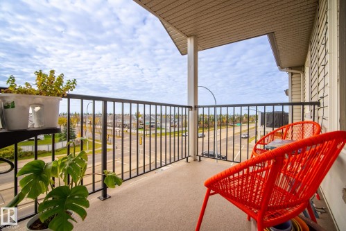 Balcony featuring a black metal railing and durable outdoor flooring - #416 111 Edwards Dr Sw, Edmonton, AB 