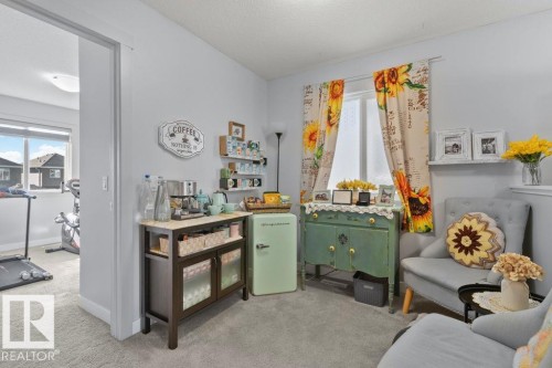 Interior room featuring neutral wall paint, wall-to-wall carpeting, and a window with a recessed sill - 6818 Evans Wynd Nw, Edmonton, AB 