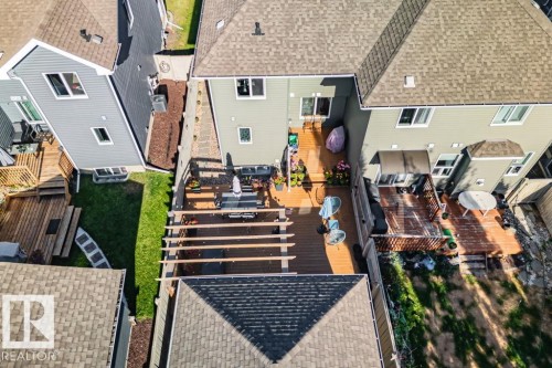 Multi-level wood deck featuring a pergola, tiered platforms, and privacy fencing - 6818 Evans Wynd Nw, Edmonton, AB 