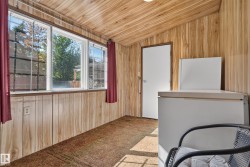 Room featuring wood-finish paneling on walls and ceiling - 