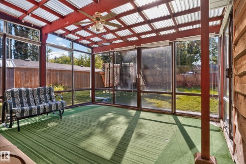 Enclosed sunroom featuring a ceiling fan, wall-mounted lighting, and a clear panel roof - 14 Sonora Drive, St. Albert, AB 