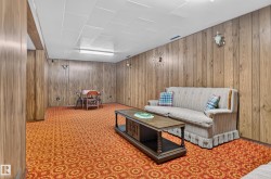 Wood-panel walls with integrated sconce lighting and ceiling-mounted fluorescent fixture - 