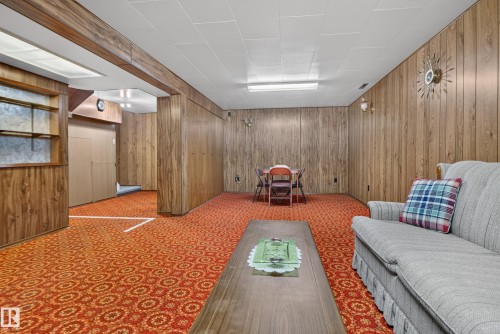 Wood paneling throughout the space, dropped ceiling with fluorescent lighting, and built-in shelving - 14 Sonora Drive, St. Albert, AB 