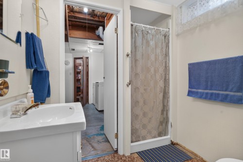 White vanity with integrated sink, chrome faucet, and mirrored medicine cabinet - 14 Sonora Drive, St. Albert, AB 