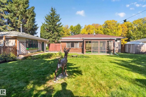 Expansive rear yard featuring a screened-in porch, mature trees, and a storage shed - 14 Sonora Drive, St. Albert, AB 
