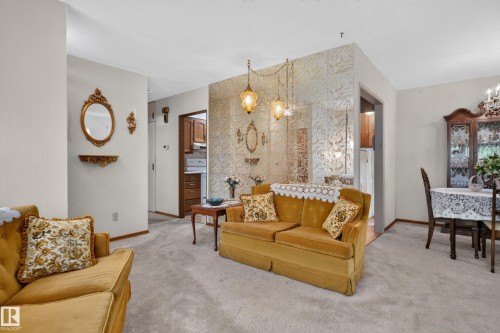 Carpeted flooring throughout, recessed entryway, built-in wall partition, and wood-finish door frames - 14 Sonora Drive, St. Albert, AB 