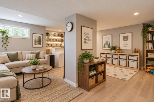 Open-concept interior featuring recessed lighting, wood-finish flooring, a central structural column, and built-in recessed shelving with integrated lighting - 225 Heagle Crescent Nw, Edmonton, AB 