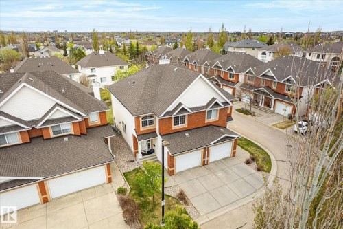 Brick exterior with white siding accents and a pitched asphalt shingle roof - 2550 Rabbit Hill Road Nw, Edmonton, AB 