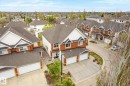 Brick exterior with white siding accents and a pitched asphalt shingle roof - 2550 Rabbit Hill Road Nw, Edmonton, AB 