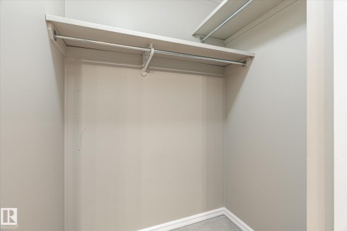Built-in shelving with hanging rods - 2550 Rabbit Hill Road Nw, Edmonton, AB 