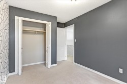 Carpeted flooring, bi-fold closet doors, white trim, and a white interior door - 