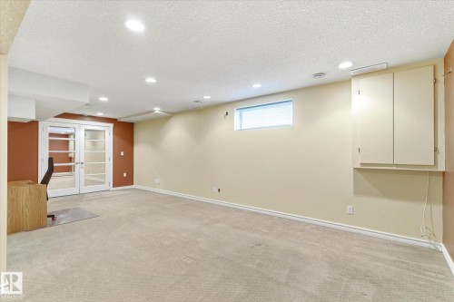 Recessed lighting, light-toned carpeting, built-in wall cabinetry, and a transom window - 2550 Rabbit Hill Road Nw, Edmonton, AB 