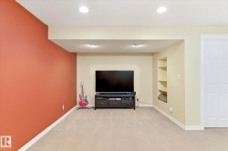 Recessed lighting, built-in shelving, and a paneled door - 