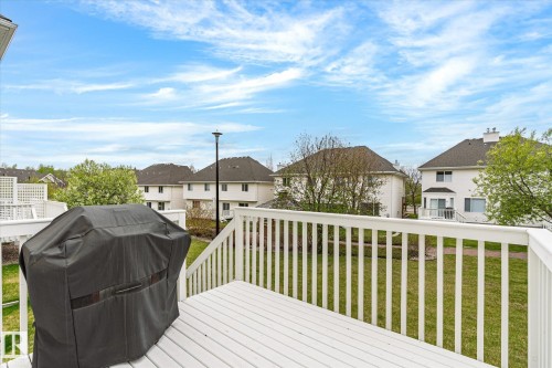 Expansive outdoor deck with white railing, overlooking a lush green lawn - 2550 Rabbit Hill Road Nw, Edmonton, AB 