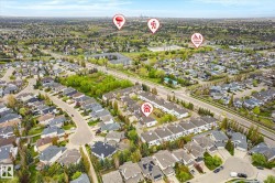 Aerial perspective showcasing a residential community with abundant green spaces, established streets, and mature landscaping - 