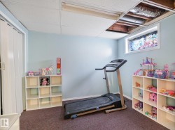 Recessed fluorescent lighting, drop ceiling, light blue painted walls, and an egress window - 