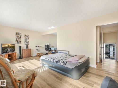 Wood-finish flooring throughout the space - 7520 130 Avenue Nw, Edmonton, AB 