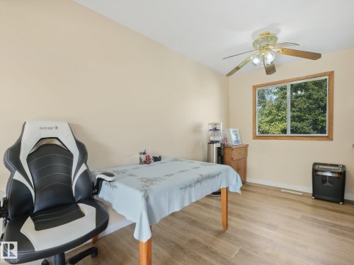 Wood-finish flooring, neutral wall paint, and a built-in ceiling fan with lighting - 7520 130 Avenue Nw, Edmonton, AB 