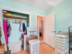 Built-in closet with a wood-finish shelf and hanging rod - 