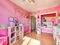 Wood-finish flooring with a light tone, ceiling fan with integrated lighting, and built-in shelving - 