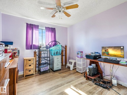 Wood-finish flooring, ceiling fan with integrated lighting, and a single window - 7520 130 Avenue Nw, Edmonton, AB 