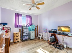 Wood-finish flooring, ceiling fan with integrated lighting, and a single window - 