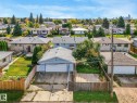 Residential property with a single-story structure, a paved driveway, a two-car attached garage, and a fenced backyard - 7520 130 Avenue Nw, Edmonton, AB 