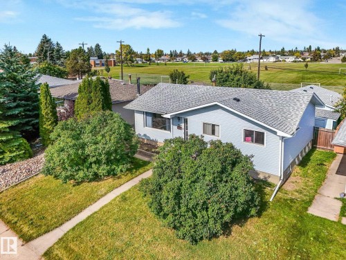 Light blue vinyl siding exterior with a gray asphalt shingle roof - 7520 130 Avenue Nw, Edmonton, AB 