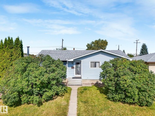 Light blue siding exterior with a grey shingle roof - 7520 130 Avenue Nw, Edmonton, AB 