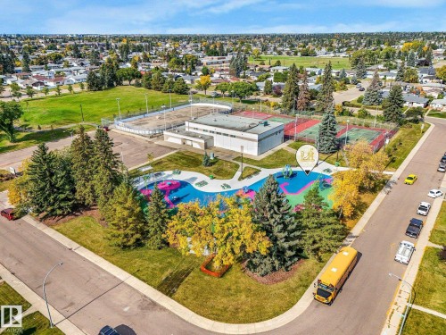 Community recreational area featuring a splash park, multiple tennis courts, and an outdoor ice rink - 7520 130 Avenue Nw, Edmonton, AB 