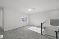 Carpeted flooring with a modern glass railing, recessed lighting, and a flush mount ceiling light - 