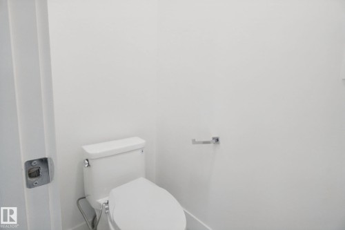 White toilet with a dual-flush system - 3699 Hummingbird Way Nw, Edmonton, AB 