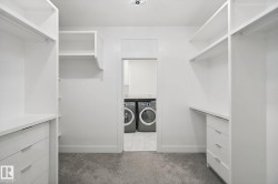 Custom closet system featuring built-in shelving, drawers with modern hardware, and hanging rods - 