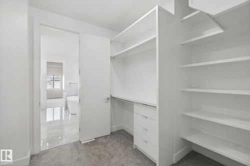Built-in shelving, hanging rod, and drawers provide ample storage - 3699 Hummingbird Way Nw, Edmonton, AB 