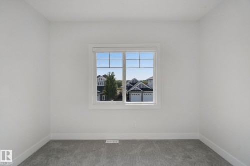 White painted walls, gray carpeting, and a white framed window - 3699 Hummingbird Way Nw, Edmonton, AB 