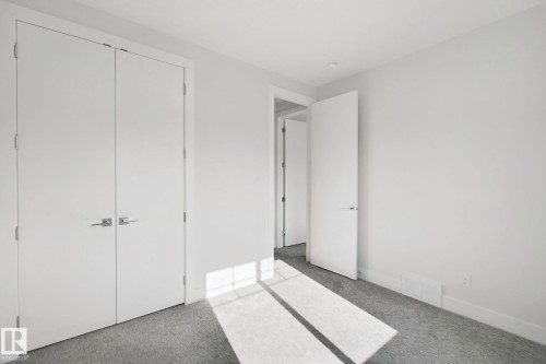 Neutral color palette, wall-to-wall carpeting, contemporary interior doors, and modern door hardware - 3699 Hummingbird Way Nw, Edmonton, AB 