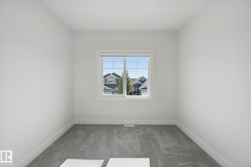 Neutral wall finishes, window with multi-pane glazing, and gray carpeting - 3699 Hummingbird Way Nw, Edmonton, AB 