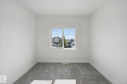 Neutral wall finishes, window with multi-pane glazing, and gray carpeting - 