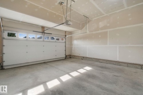 Single garage door with upper window panels - 3699 Hummingbird Way Nw, Edmonton, AB 