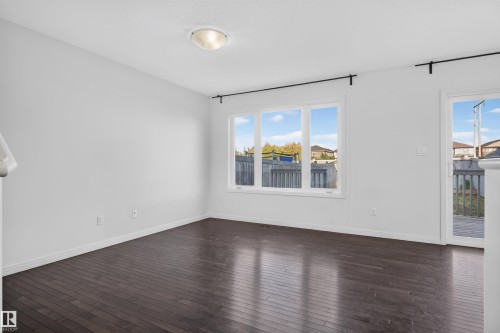 Dark wood-finish flooring with white walls and trim - 2145 28 Street Nw, Edmonton, AB 