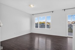 Dark wood-finish flooring with white walls and trim - 